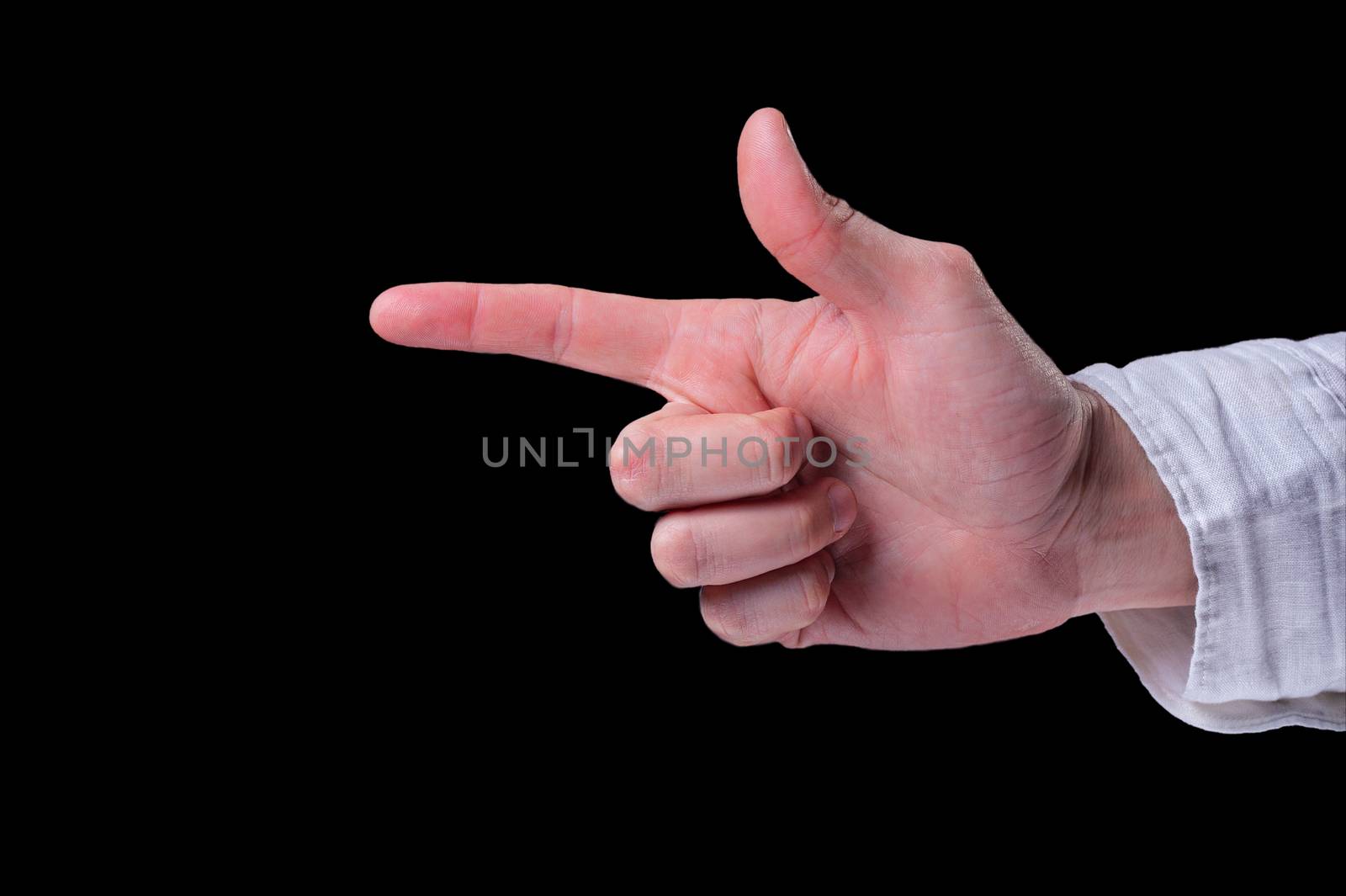 Hand of a man in a white shirt shows the finger gun sigh on isolated black background