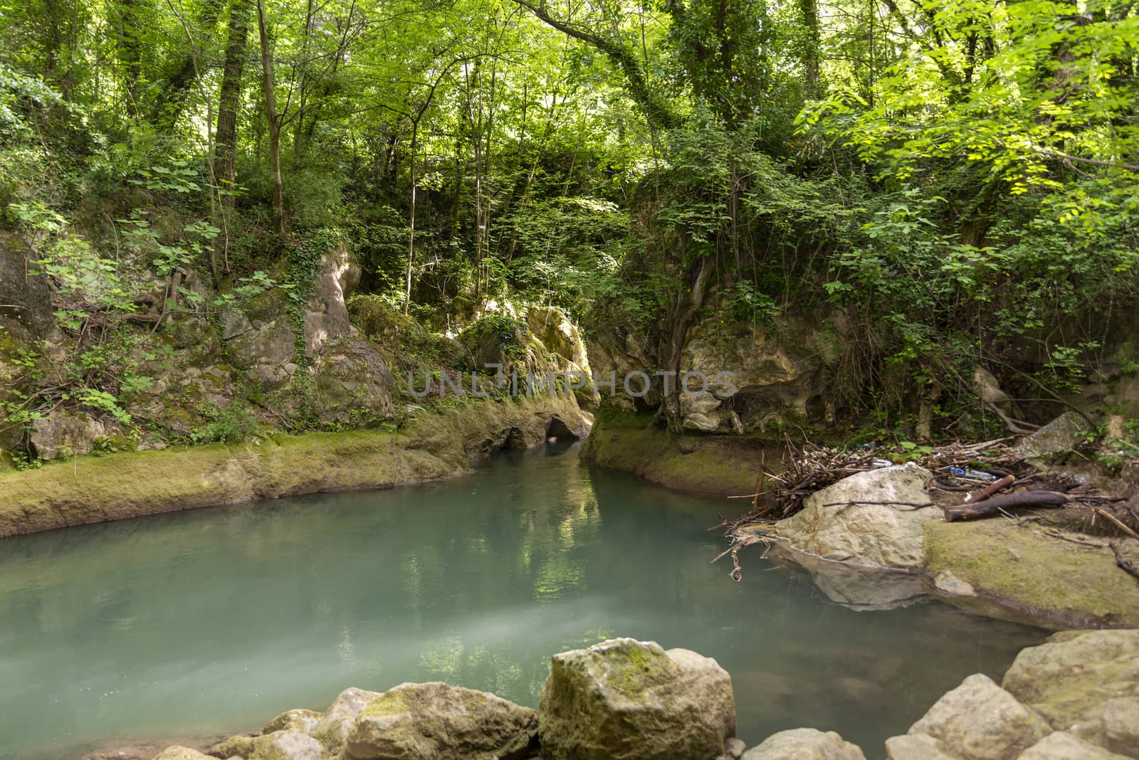 black river that comes from the marmore waterfalls in the middle of nature