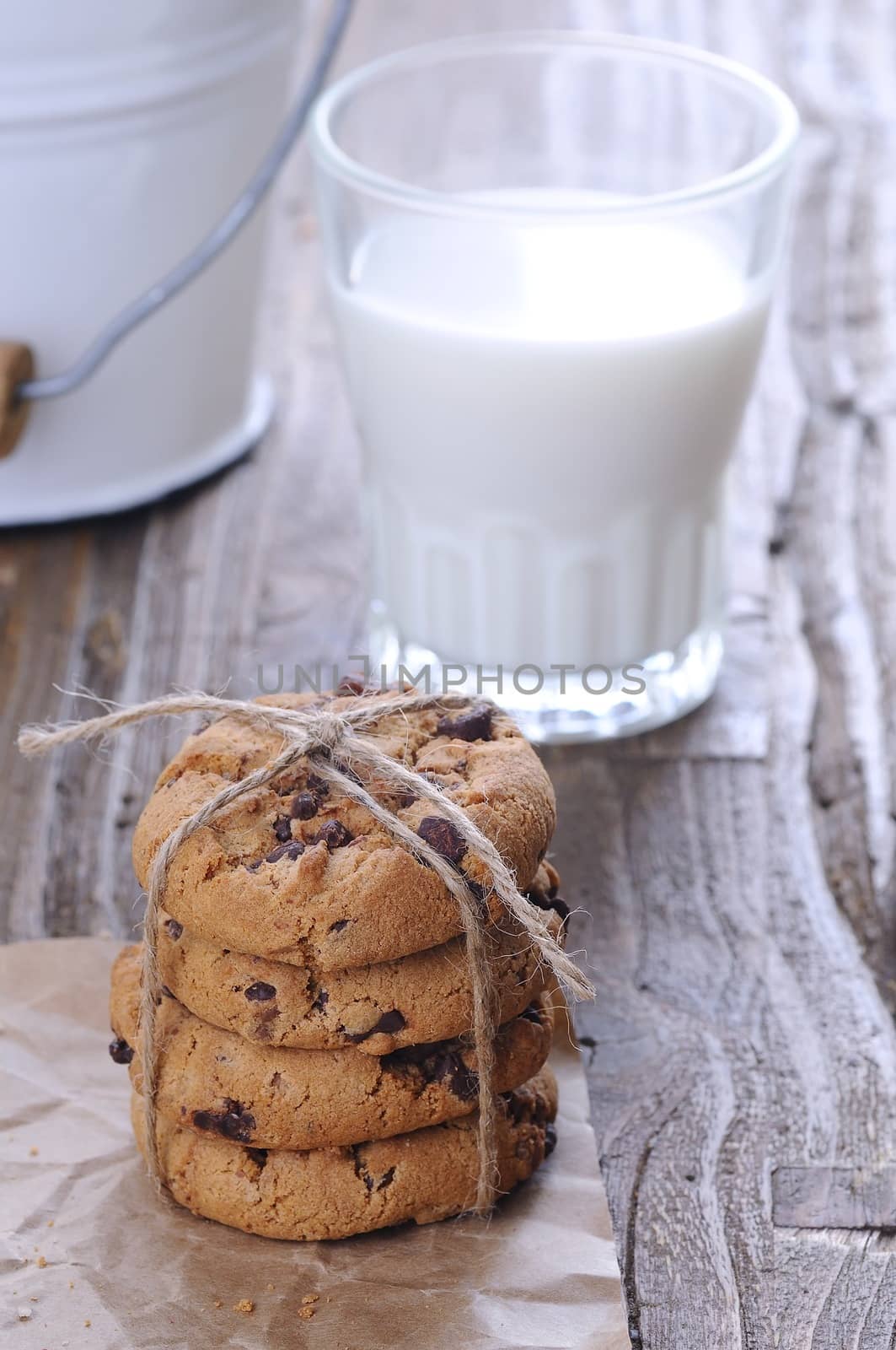 Homemade cookies with glass of milk on wooden table.