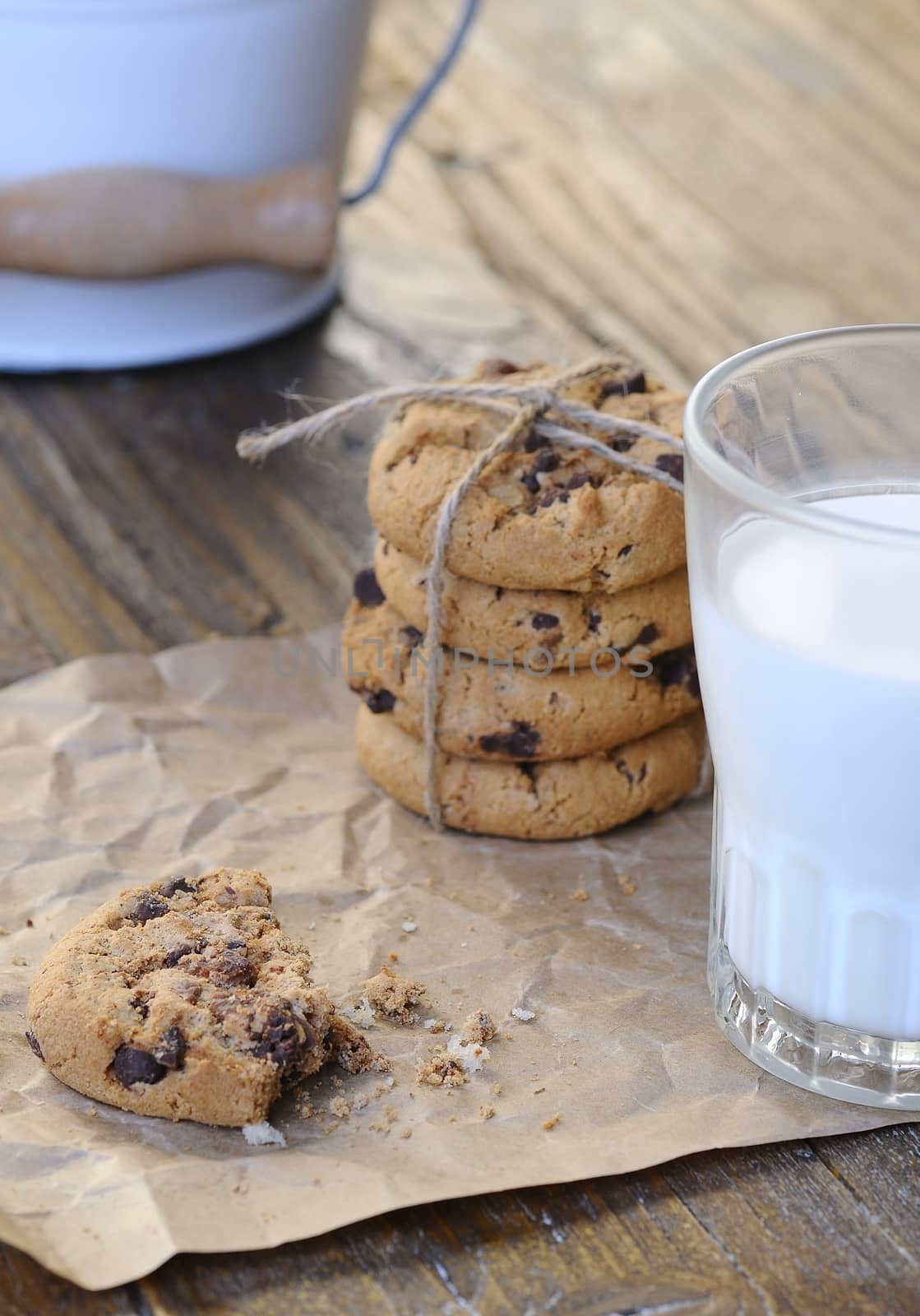 Homemade cookies with glass of milk on wooden table.