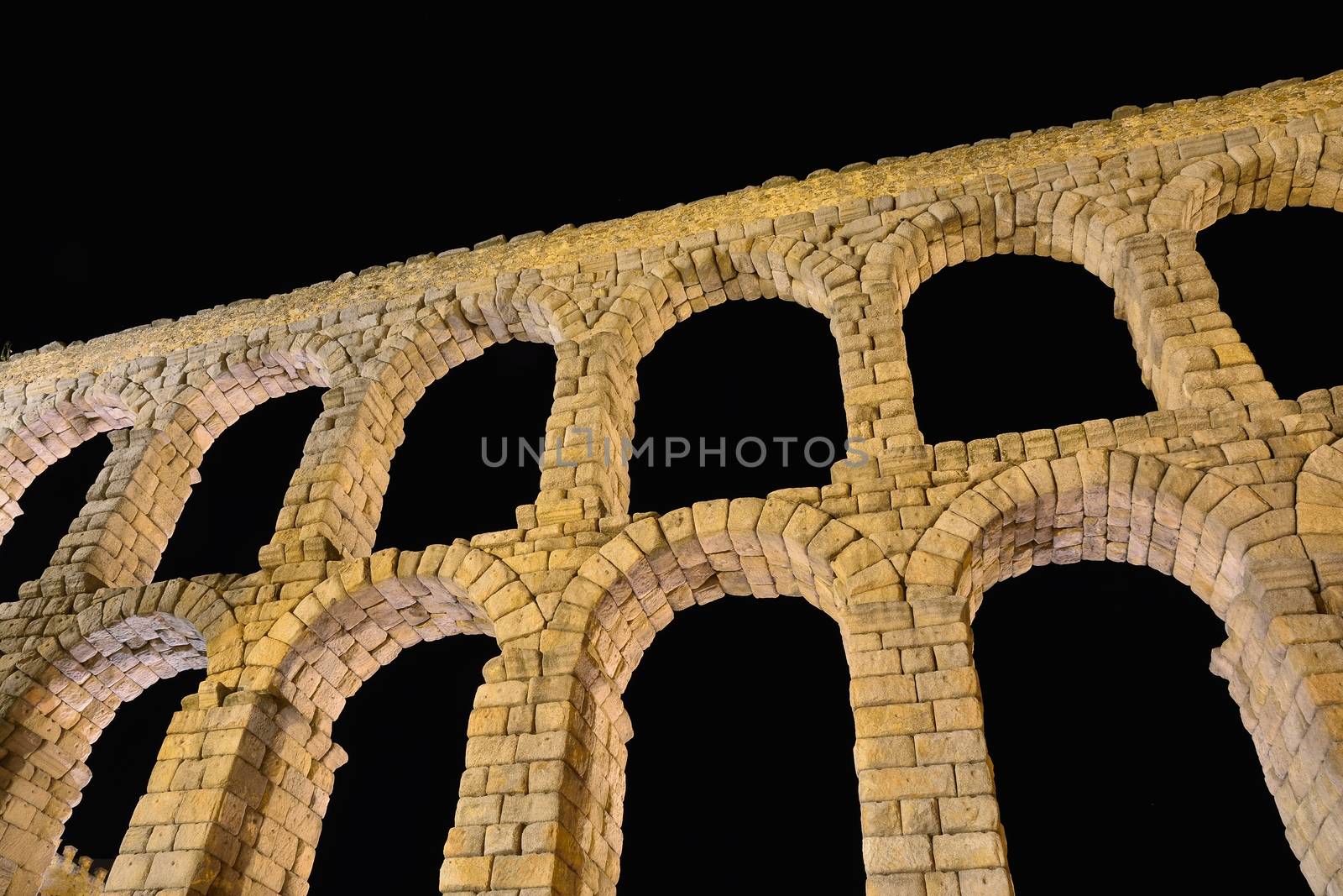 Night view of famous ancient aqueduct in Segovia, Castilla y Leon, Spain.
