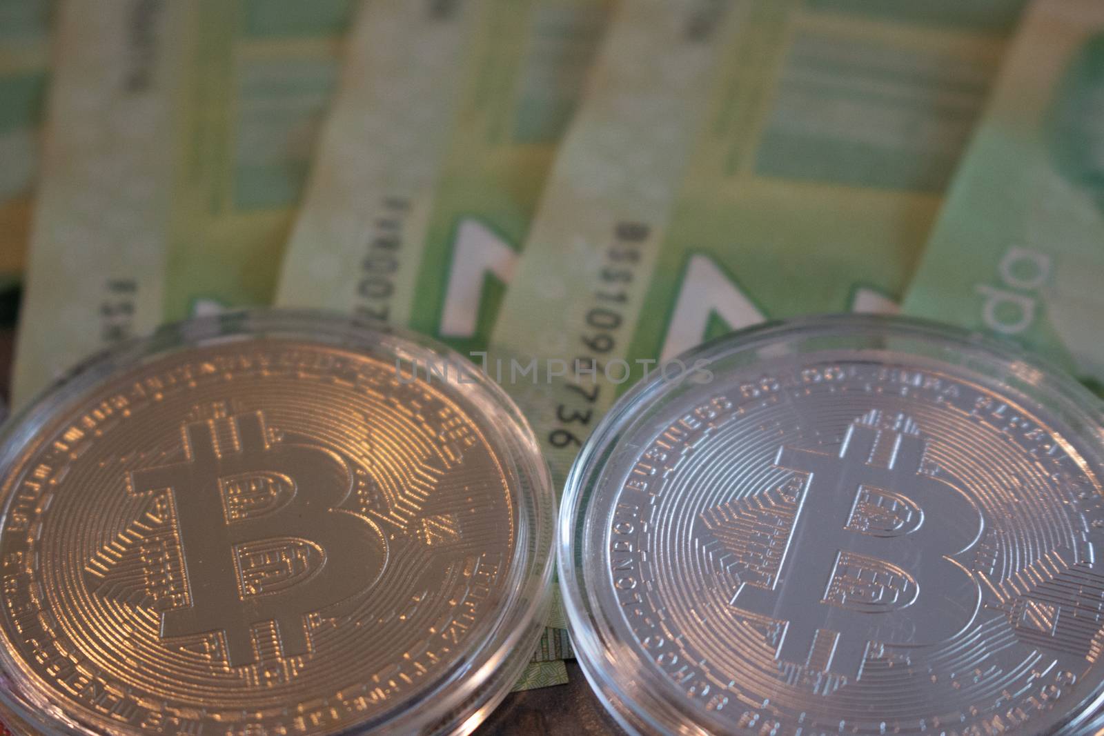 Bitcoin overtop Canadian twenty dollar bills. Theme of cryptocurrency in Canada. by mynewturtle1