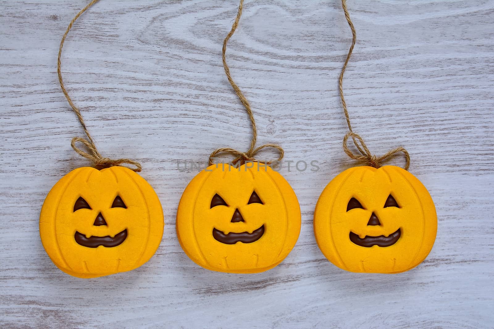 Halloween cookies with pumpkin shape on the kitchen table