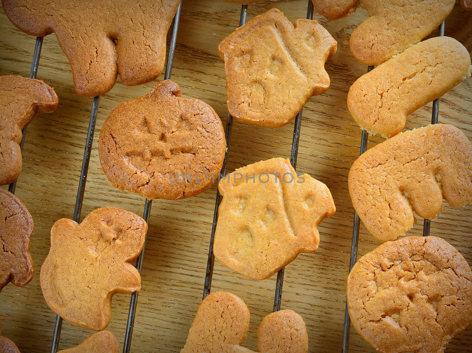 Halloween cookies with pumpkin shape on the kitchen table