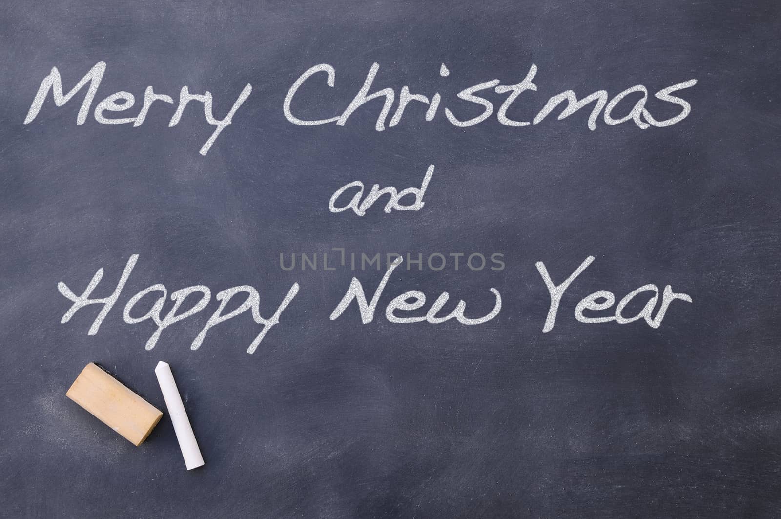 Merry Christmas and Happy New Year congratulation written on blackboard
