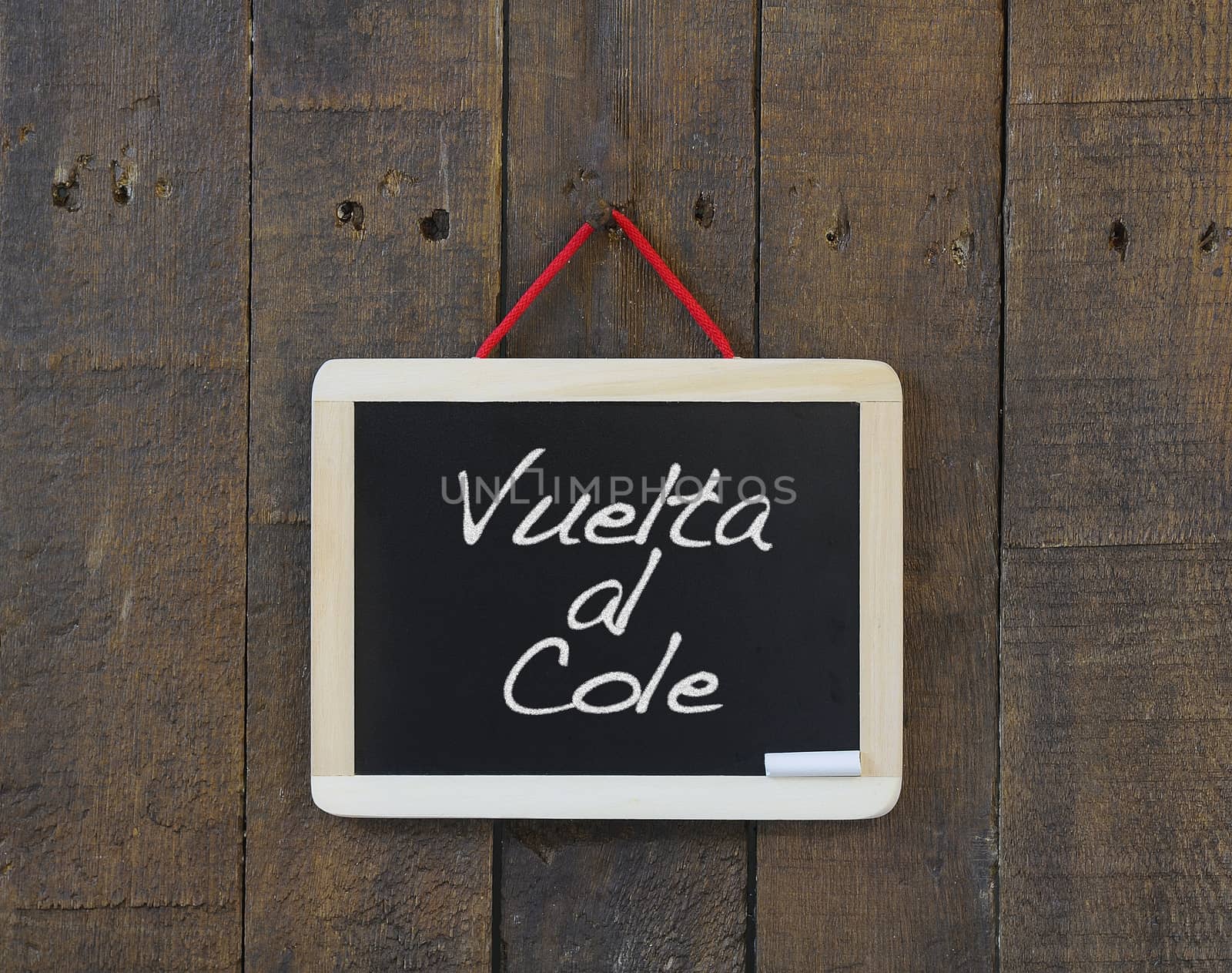 Blackboard hanging on a old wooden wall with Back to school.