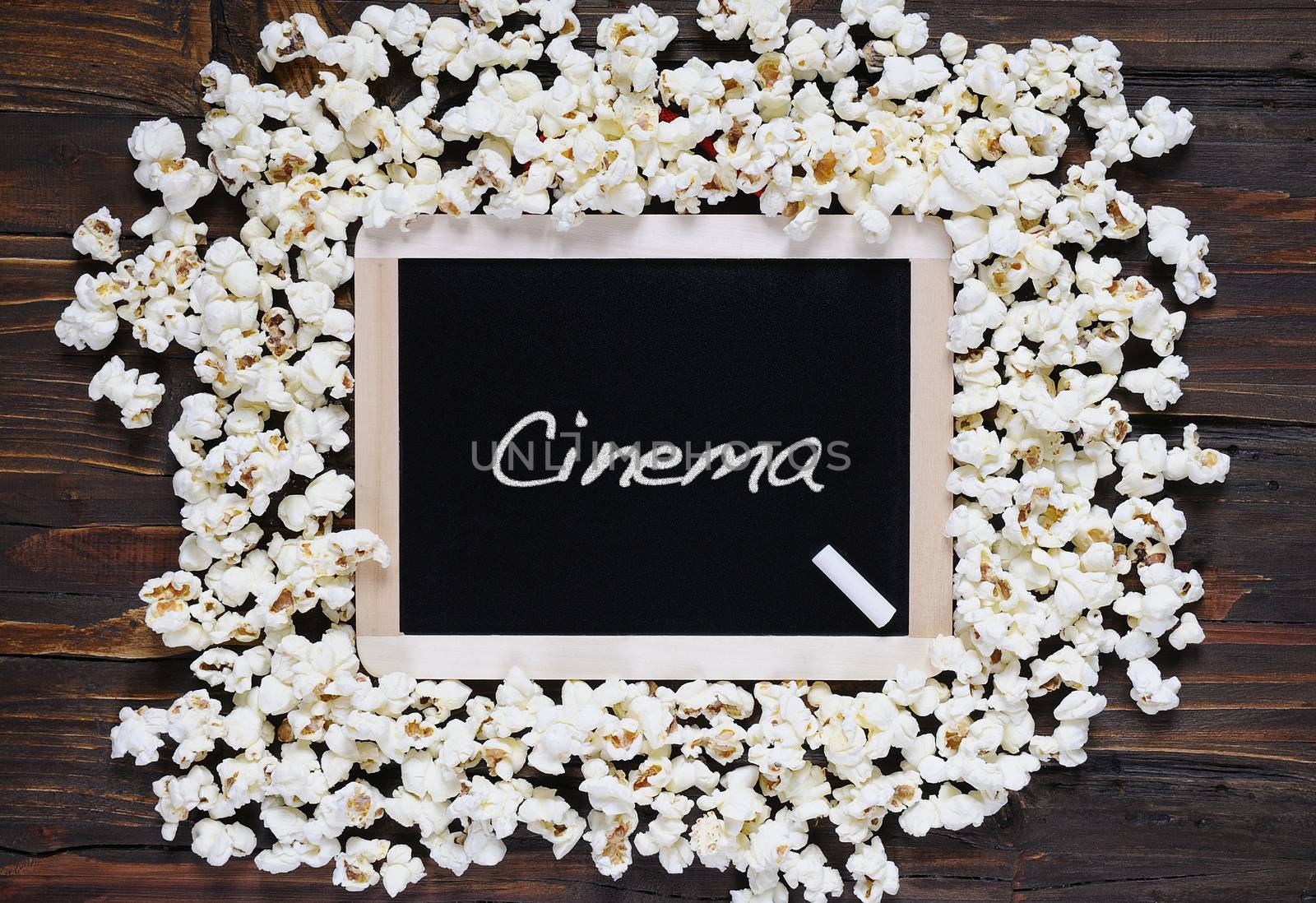 Popcorn and blackboard with the word cinema.