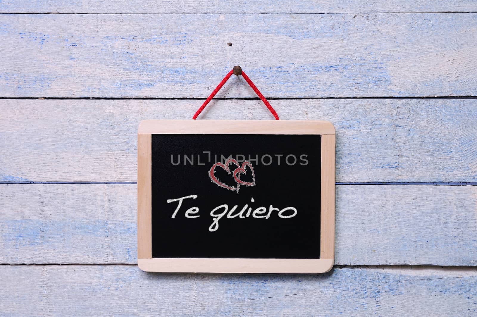Blackboard on a old wooden wall with phrase, I love you.