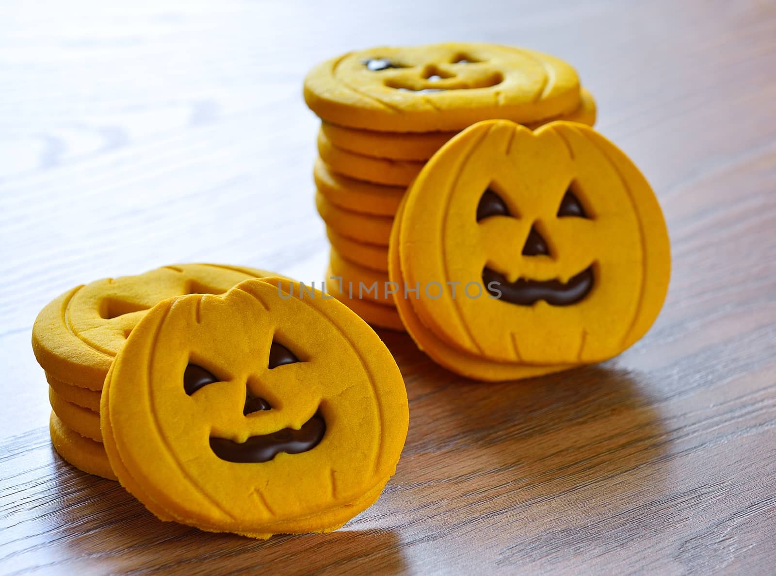 Halloween cookies with pumpkin shape on the kitchen table