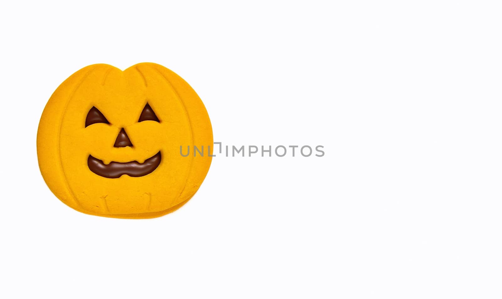 Isolated halloween cookie with pumpkin shape.