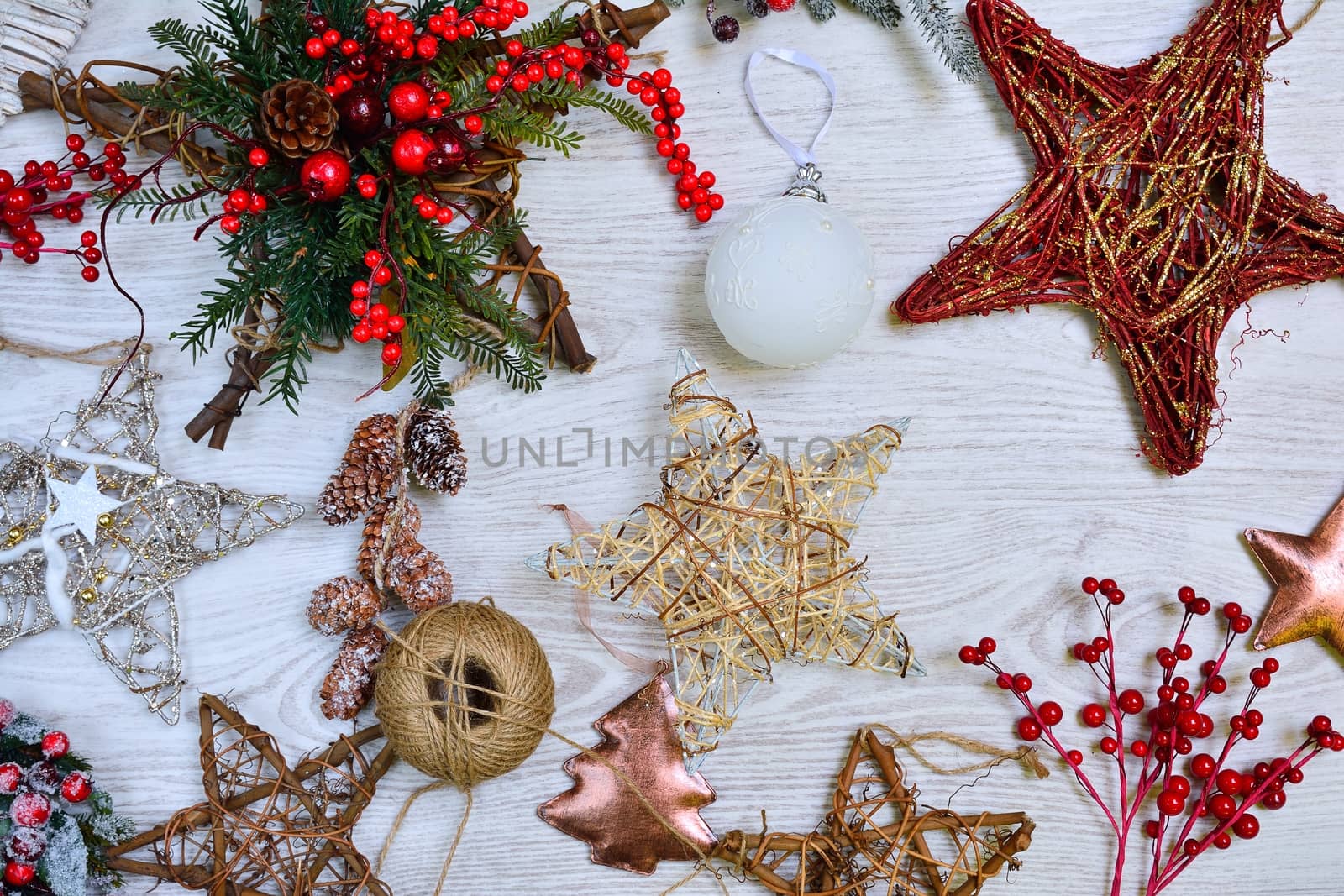 Different handmade Christmas tree decorations on wooden table. From above.