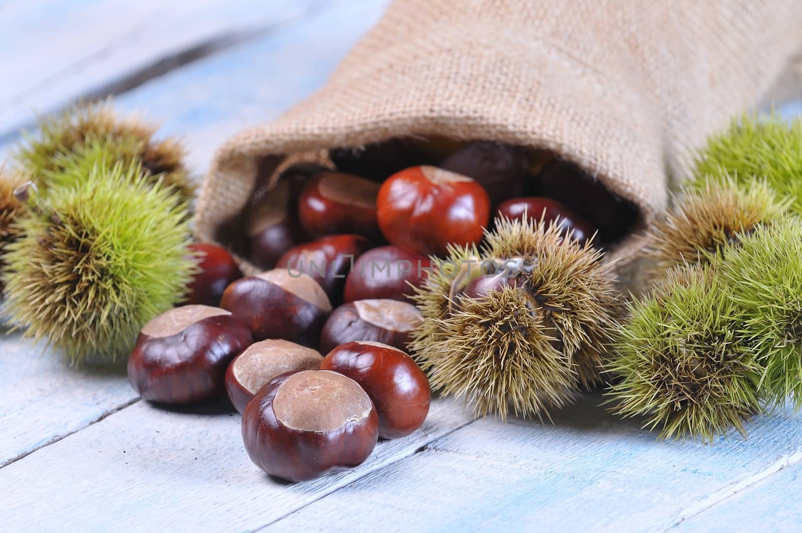 Chestnuts on wooden table in the kitchen.