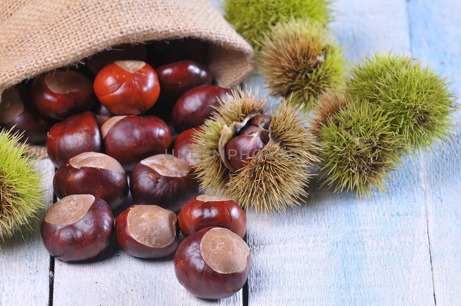 Chestnuts on wooden table in the kitchen.