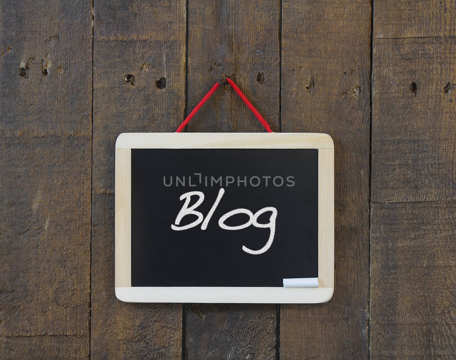 Blackboard on a wooden wall with the word Blog.