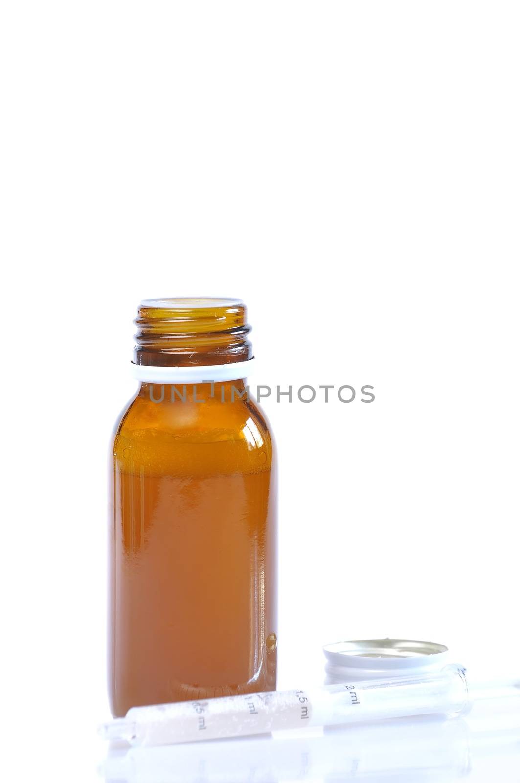 Syrup bottle with syringe on white background.