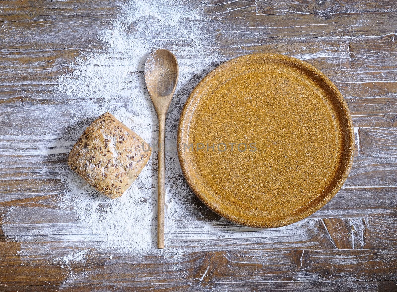 Clay dish on the table with wooden cutlery.