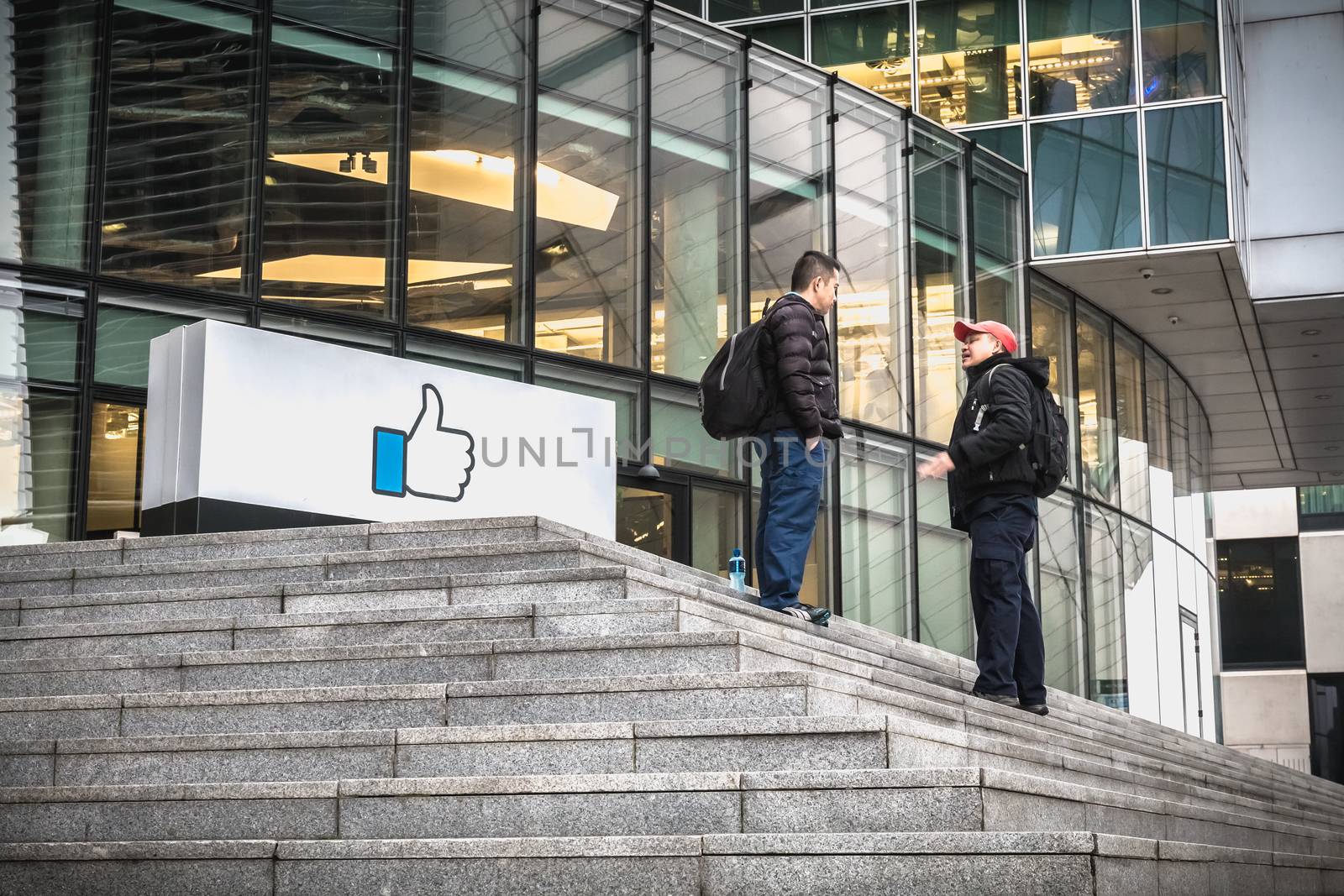 Dublin, Ireland - February 12, 2019: people talking in front of the Irish social seat of the international social network Facebook on a winter day