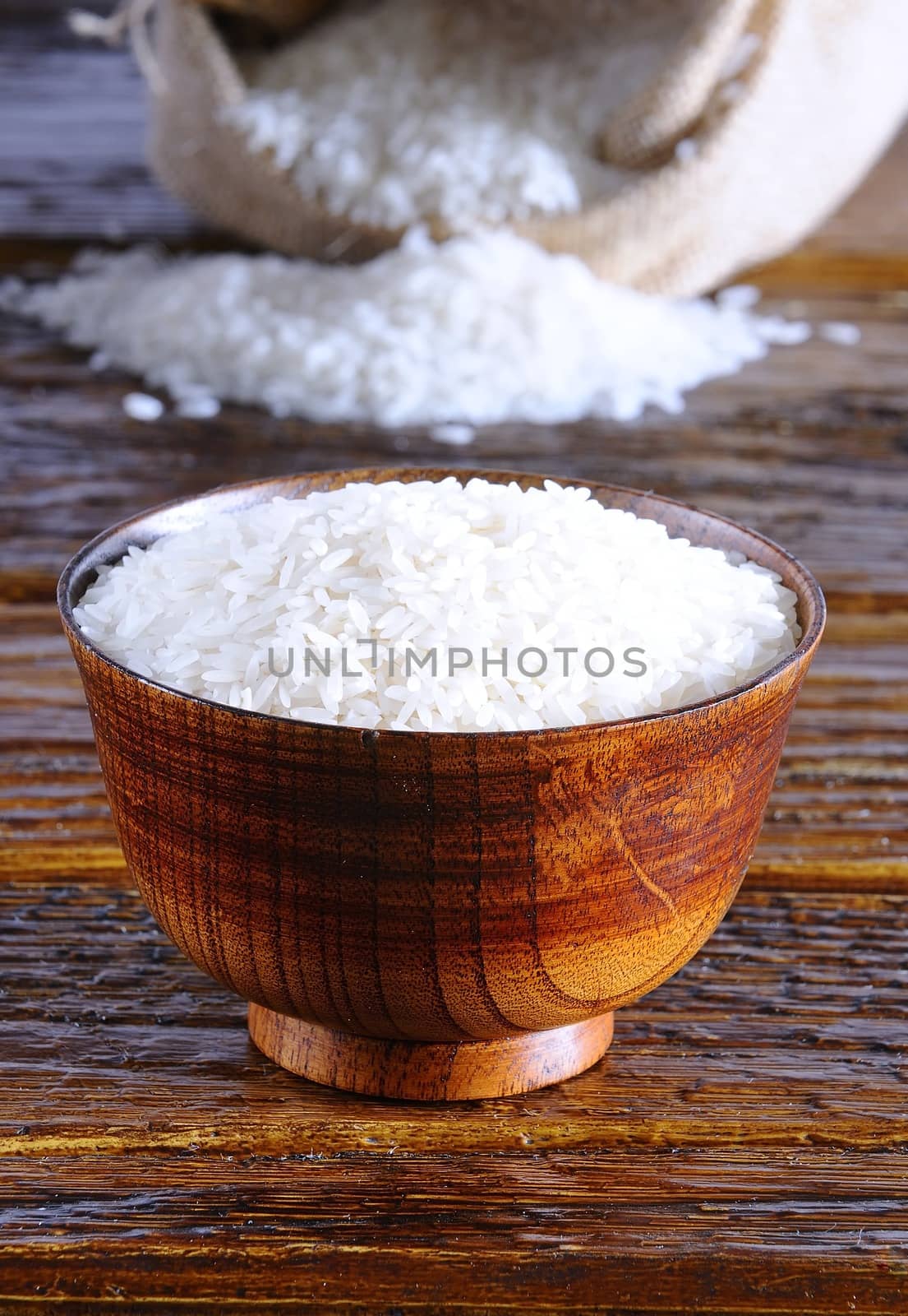 Sack of rice and bowl on a table.