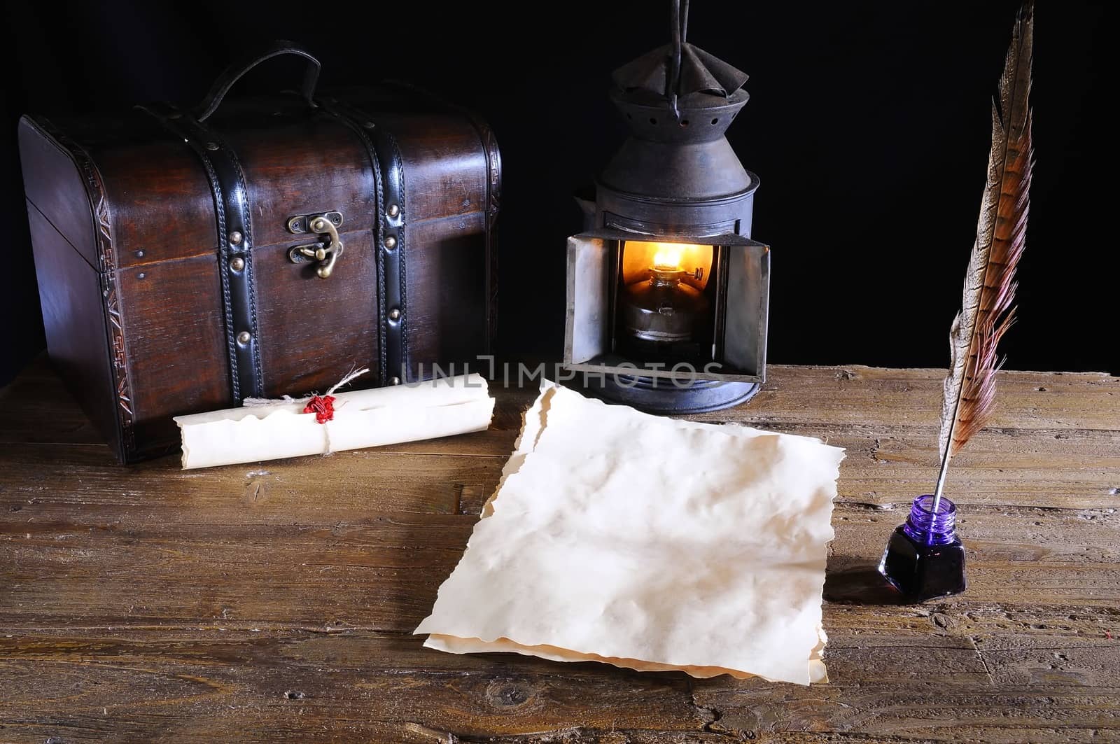 Work desk with parchment, inkwell and pen.