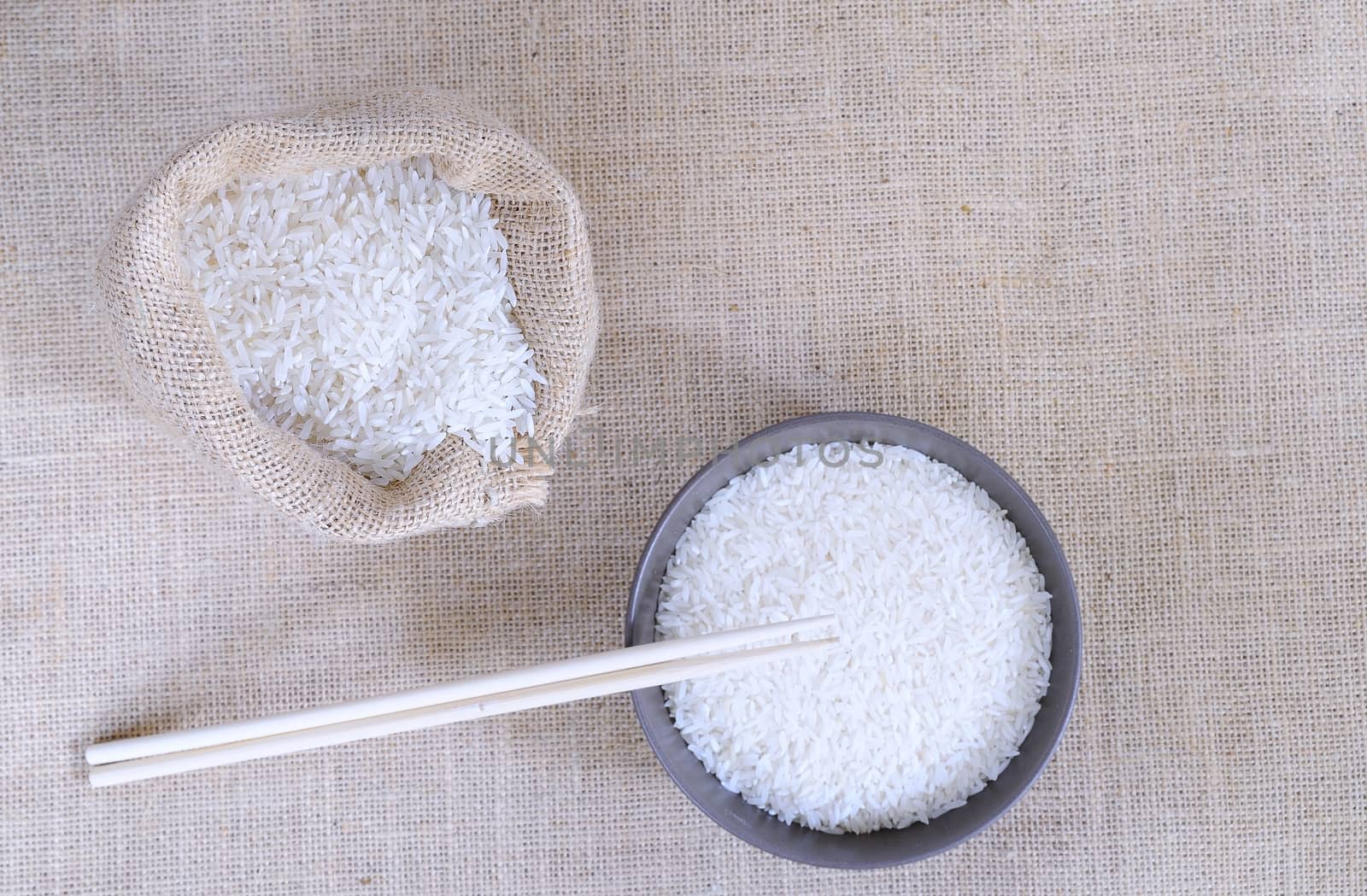 A bowl and a bag of rice on the table.