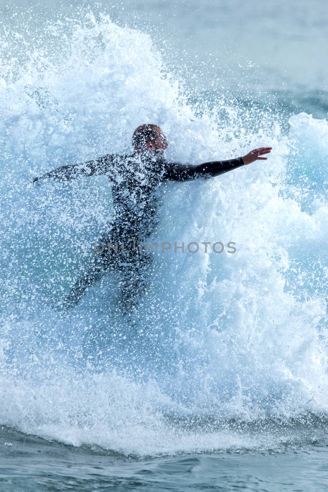 Surfer on Blue Ocean Wave with many drops