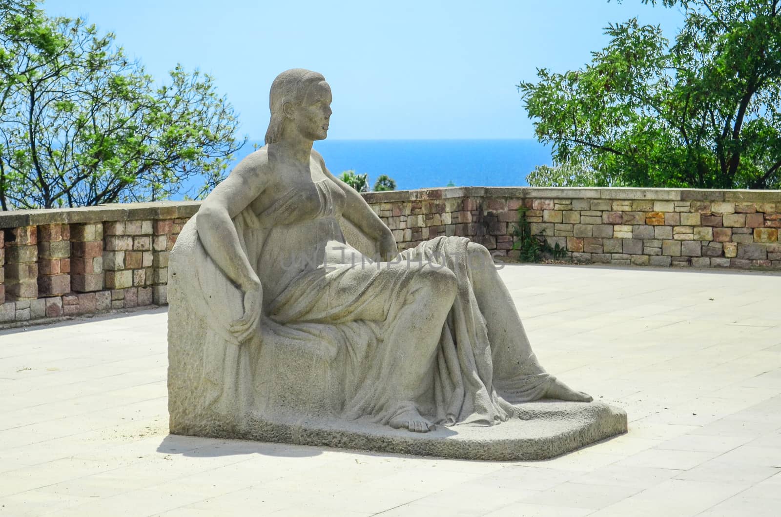 stone statue of a seated woman in Miramar on Mount Montjuïc. Barcelona, ​​Spain