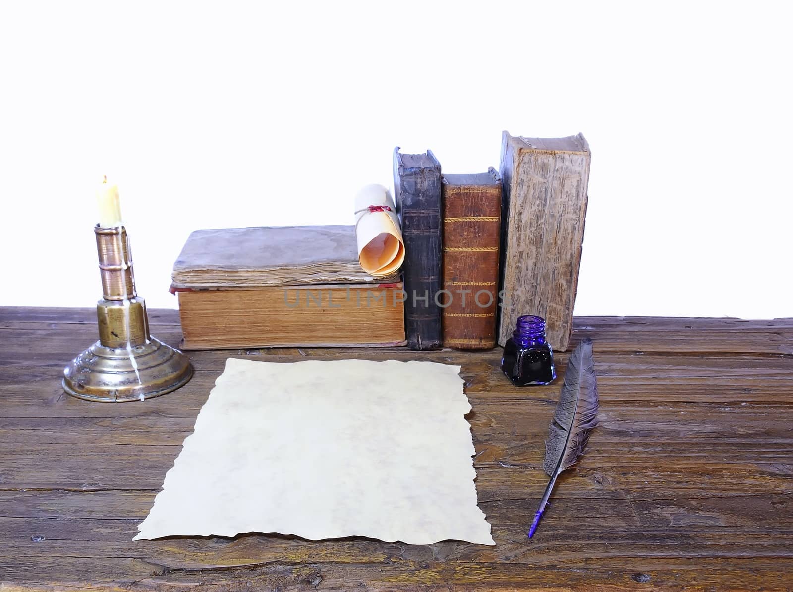 Work desk with parchment and old books.