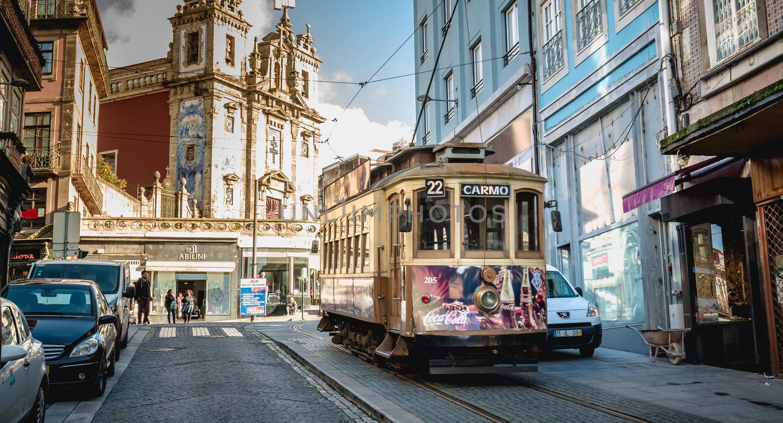 Porto, Portugal - November 30, 2018: Traditional electric tram flowing through the streets of the city on a fall day