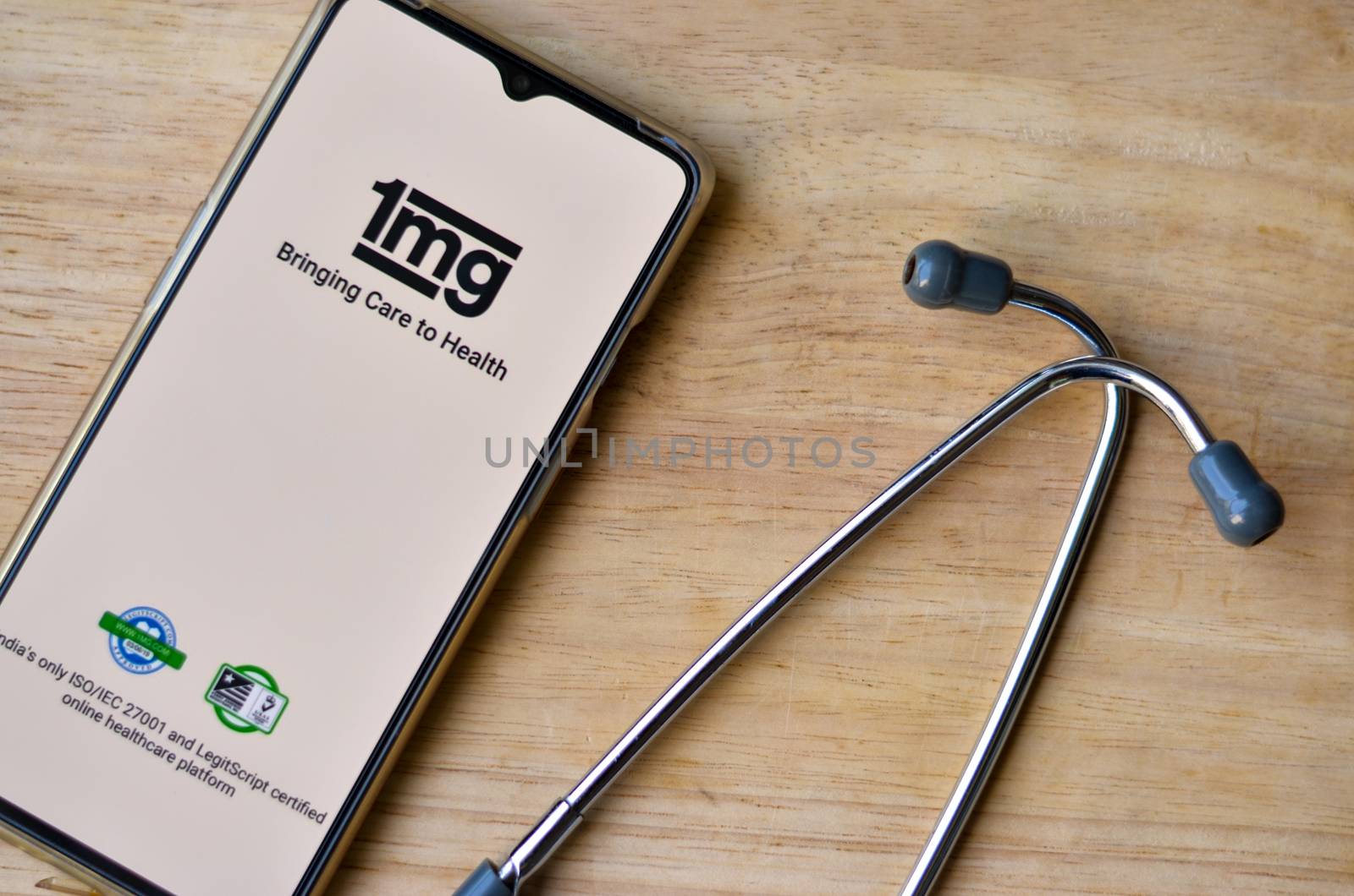 New Delhi, India, 2020.Flat Lay - Wooden background with 1MG app on the mobile phone & stethoscope. Only essential services/products are allowed to be delivered during Corona Virus (Covid-19) lockdown