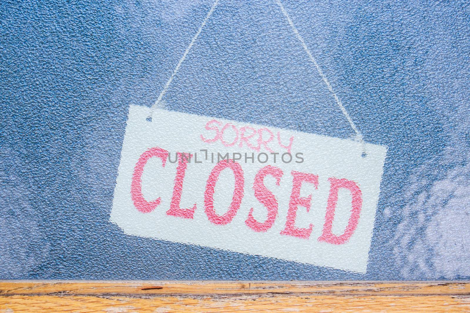 Sorry we are Closed sign in shop window by paddythegolfer