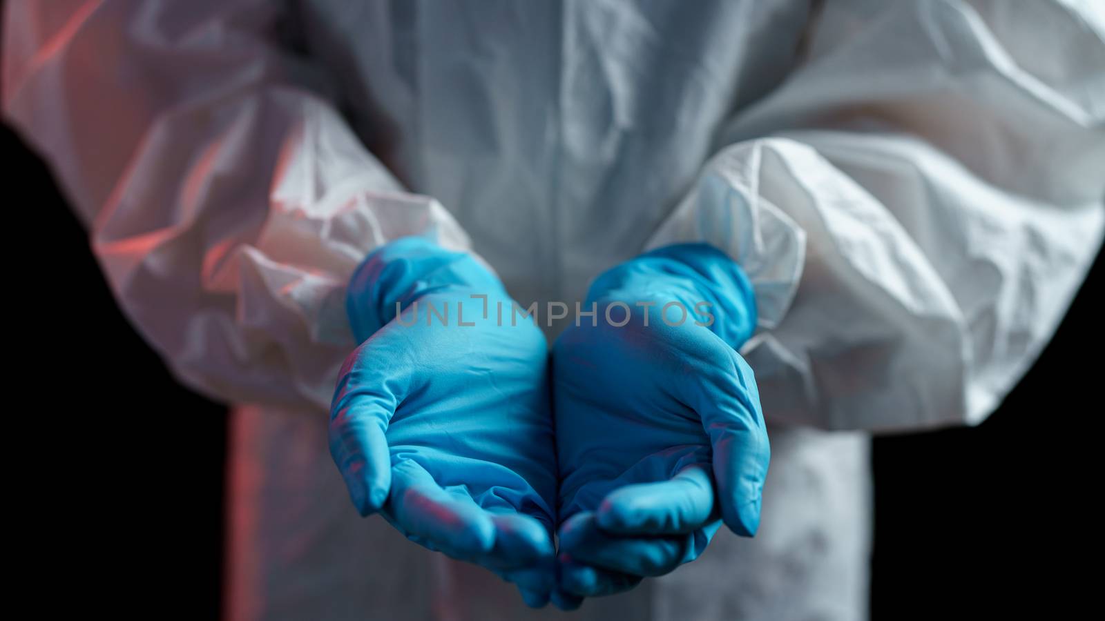 Woman in hazmat suit open the palm of the hand