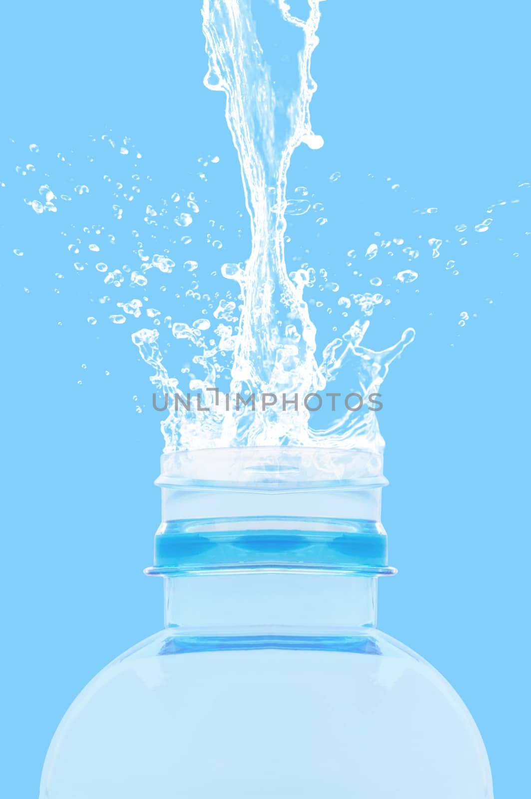 Water splash on bottle, freshness concept on blue background