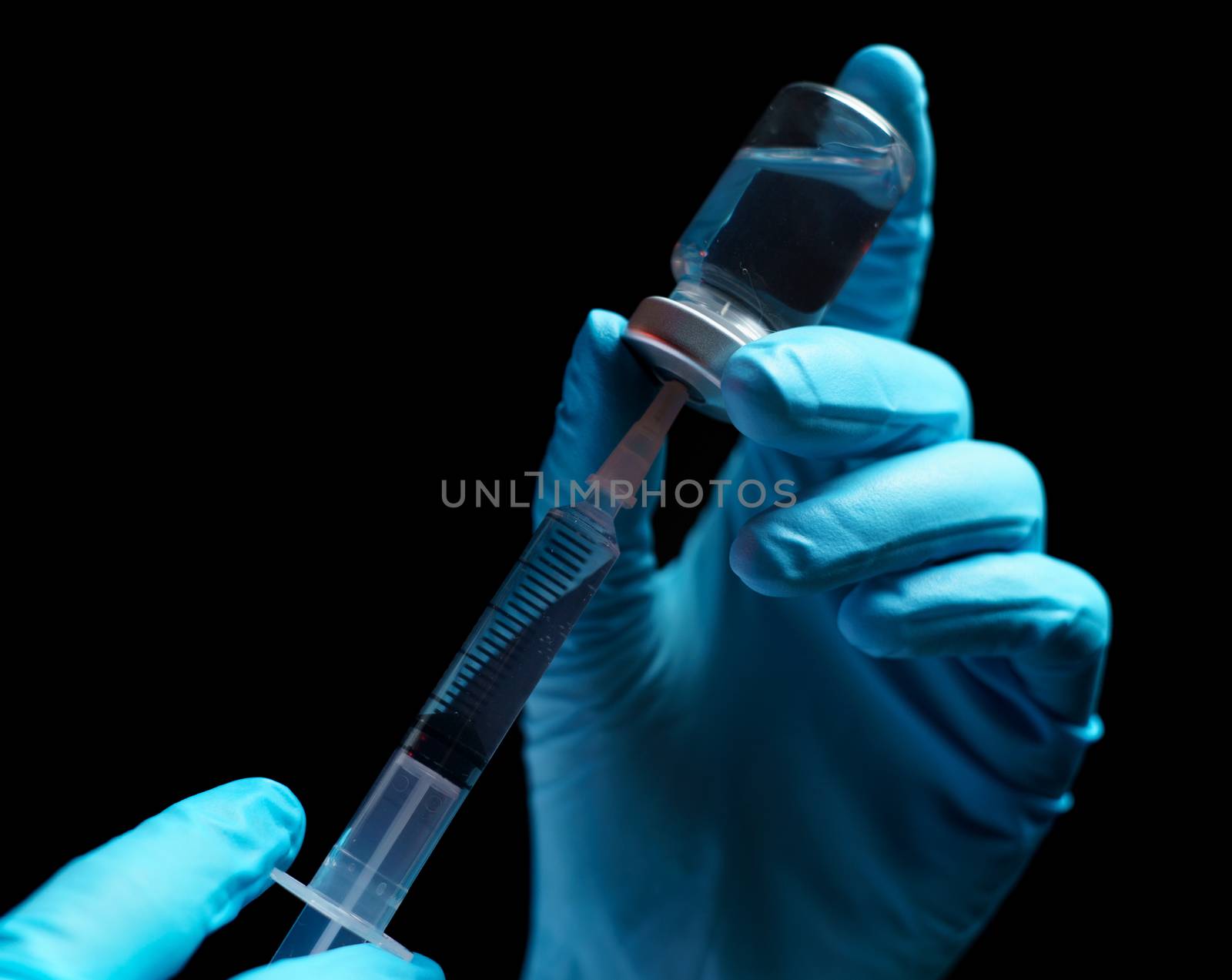 Doctor hand holding coronavirus vaccine shot for diseases outbreak vaccination, medicine and drug concept