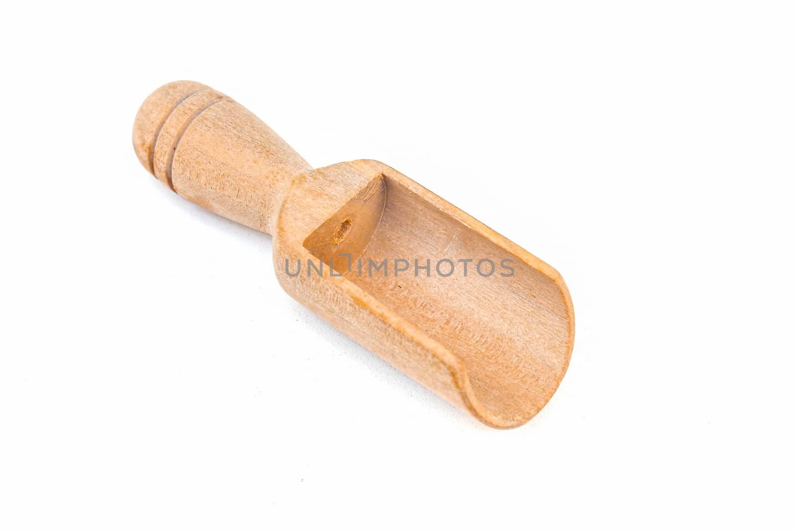 Empty wooden tea spoon on a white background by MEW