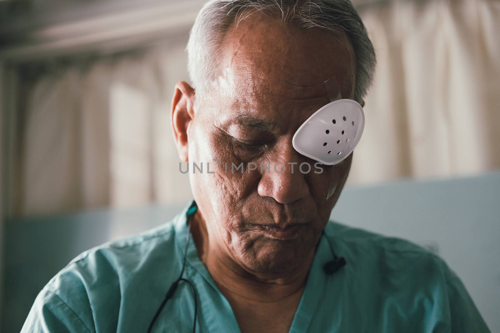 patient covering eye with protective shield after eyes cataract  by pp99