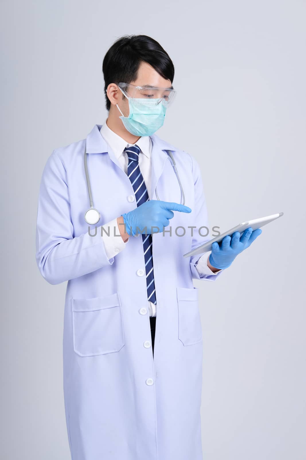 doctor physician practitioner wearing mask with tablet & stethos by pp99