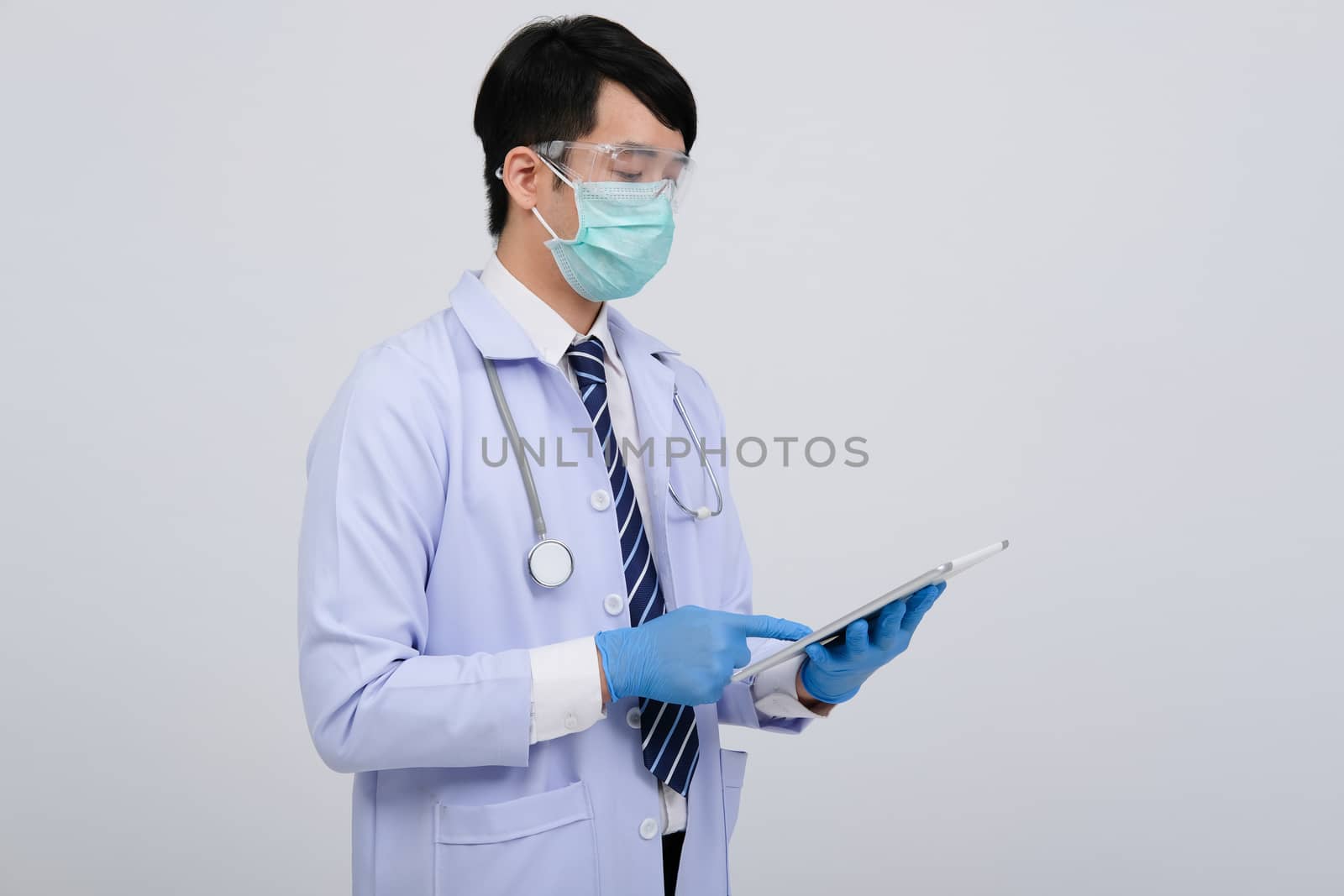 doctor physician practitioner wearing mask with tablet & stethoscope on white background. medical professional medicine healthcare concept