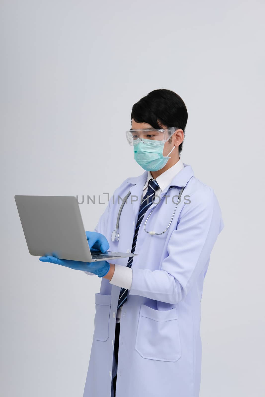 doctor physician practitioner wearing mask with computer & steth by pp99