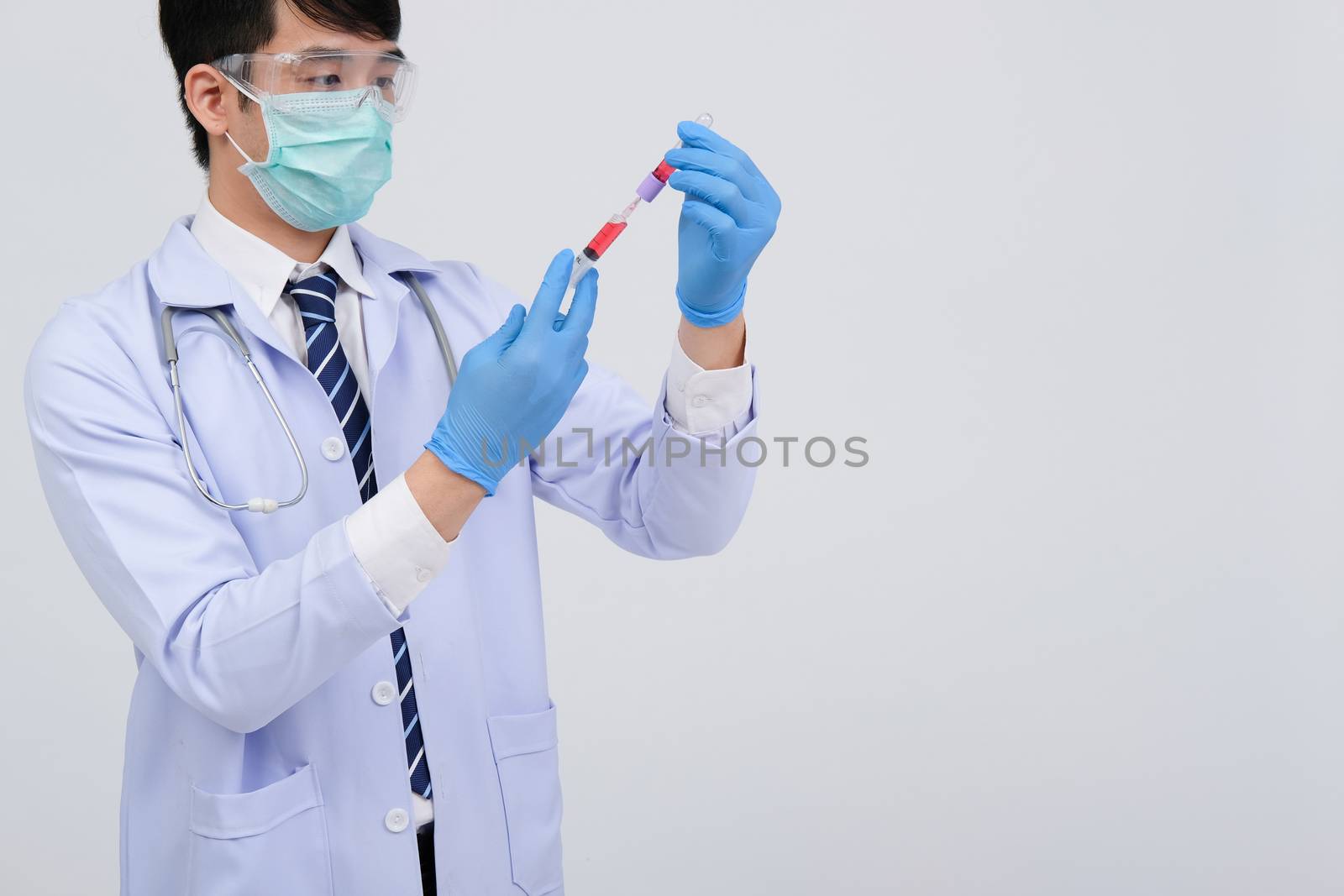 doctor physician practitioner with medicine syringe vial ampule. medical injection & needle vaccination equipment
