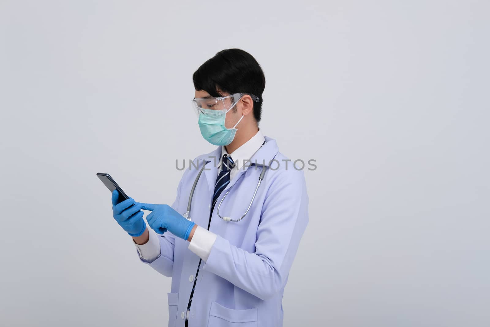 doctor physician practitioner wearing mask with smartphone & stethoscope on white background. medical professional medicine healthcare concept