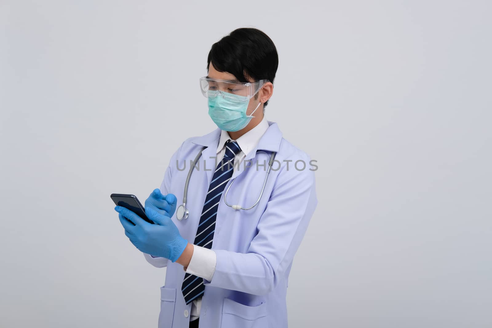 doctor physician practitioner wearing mask with smartphone & stethoscope on white background. medical professional medicine healthcare concept