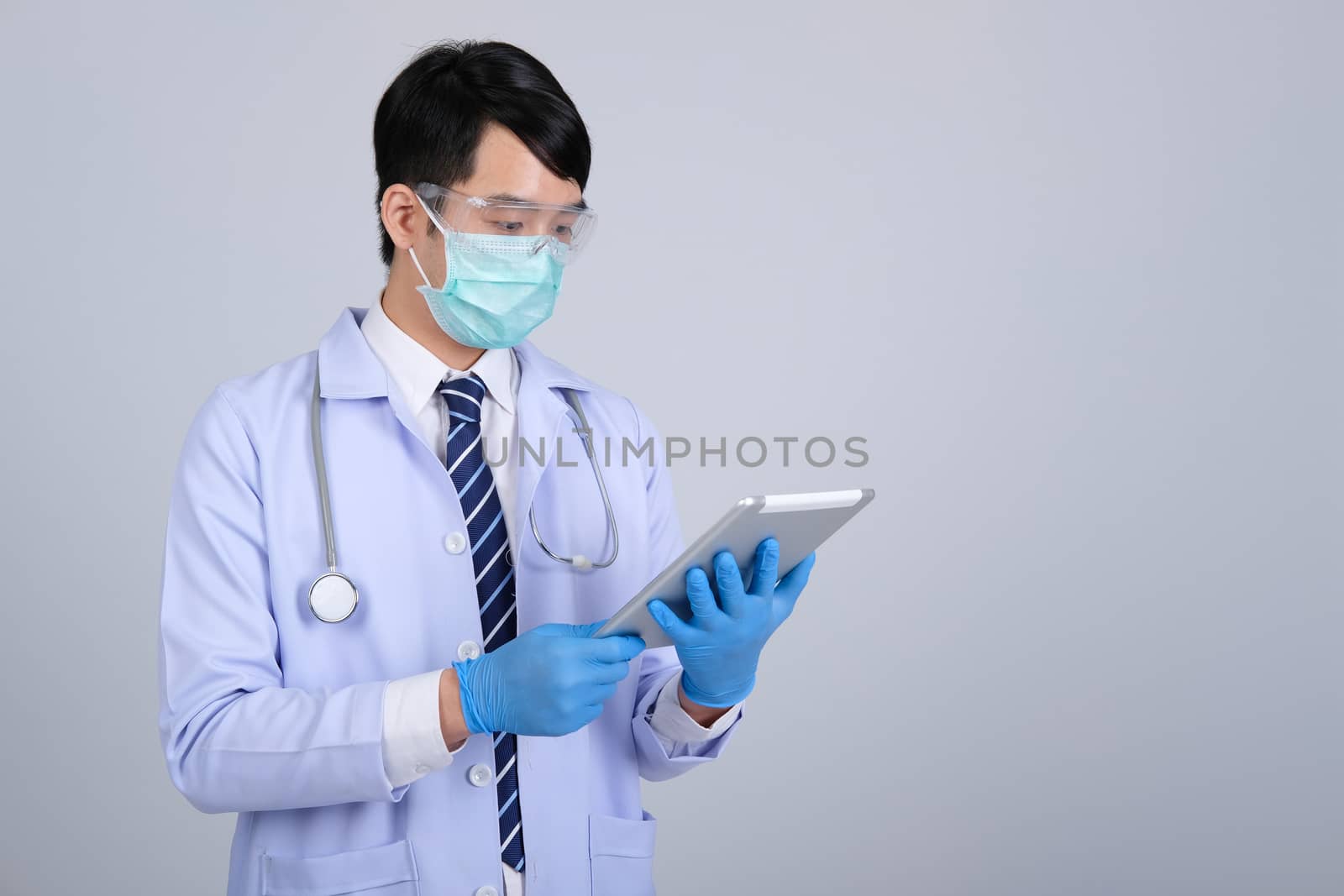 doctor physician practitioner wearing mask with tablet & stethoscope on white background. medical professional medicine healthcare concept