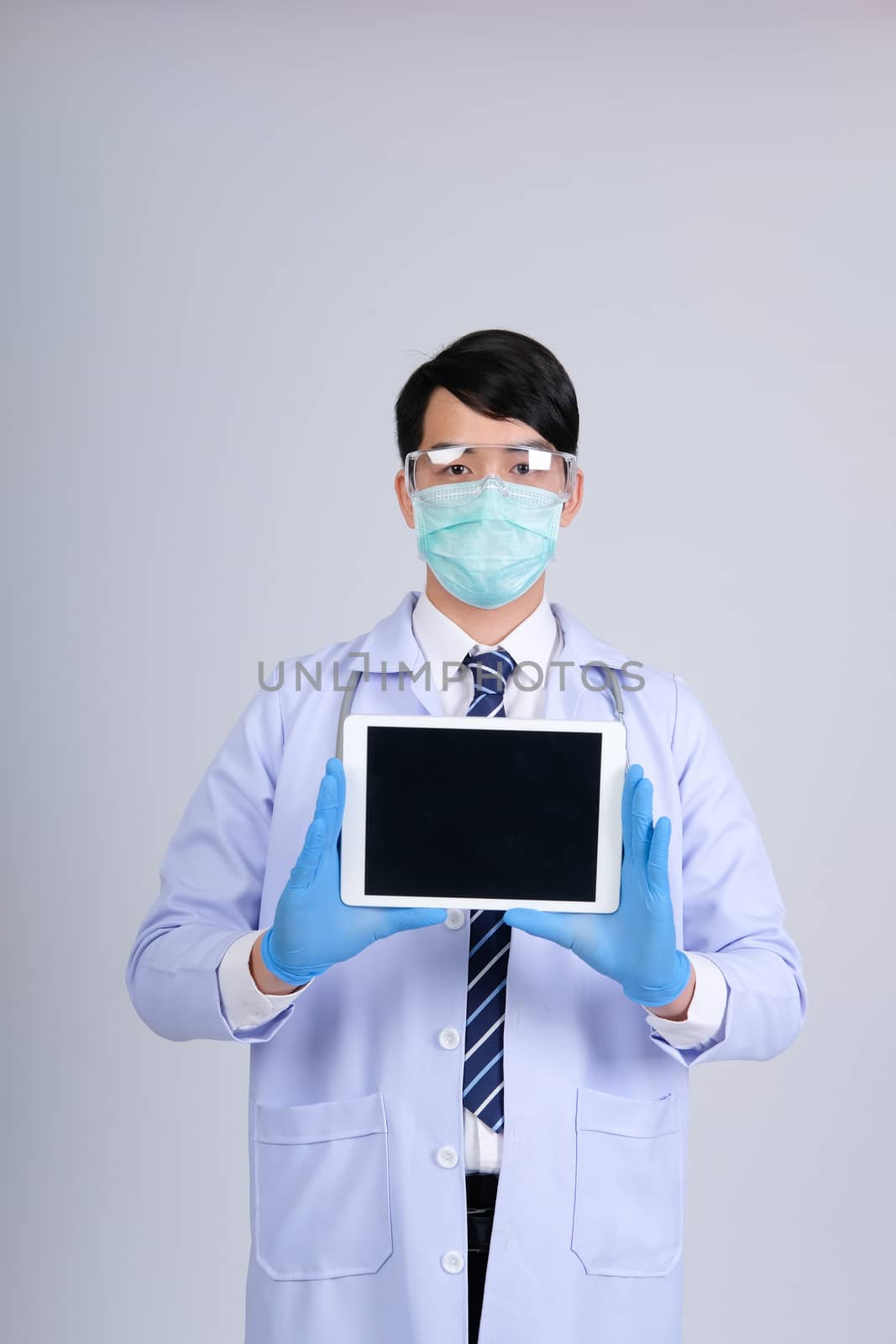 doctor physician practitioner wearing mask with tablet & stethoscope on white background. medical professional medicine healthcare concept