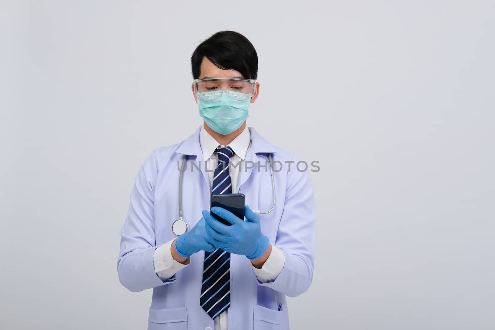 doctor physician practitioner wearing mask with smartphone & stethoscope on white background. medical professional medicine healthcare concept