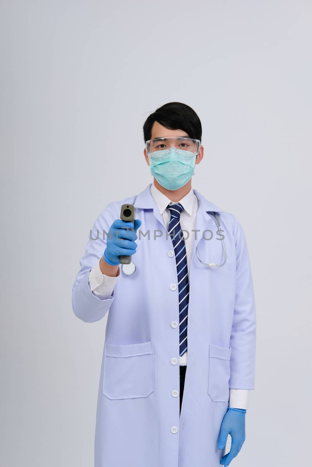 doctor physician practitioner measuring body temperature with contactless infrared forehead thermometer gun