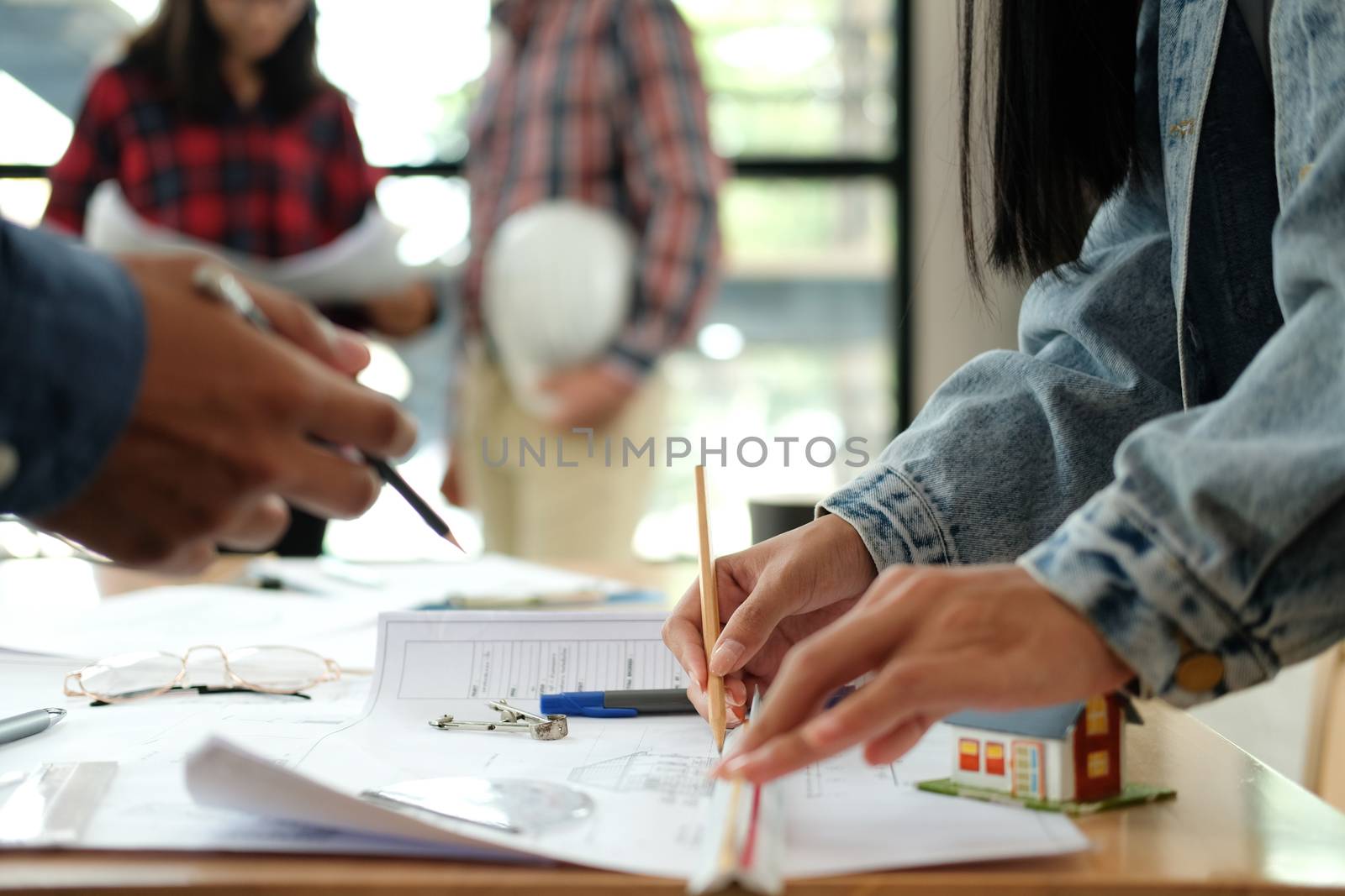 architect engineer interior designer team working discussing on house blueprint of real estate project in meeting. building construction teamwork concept