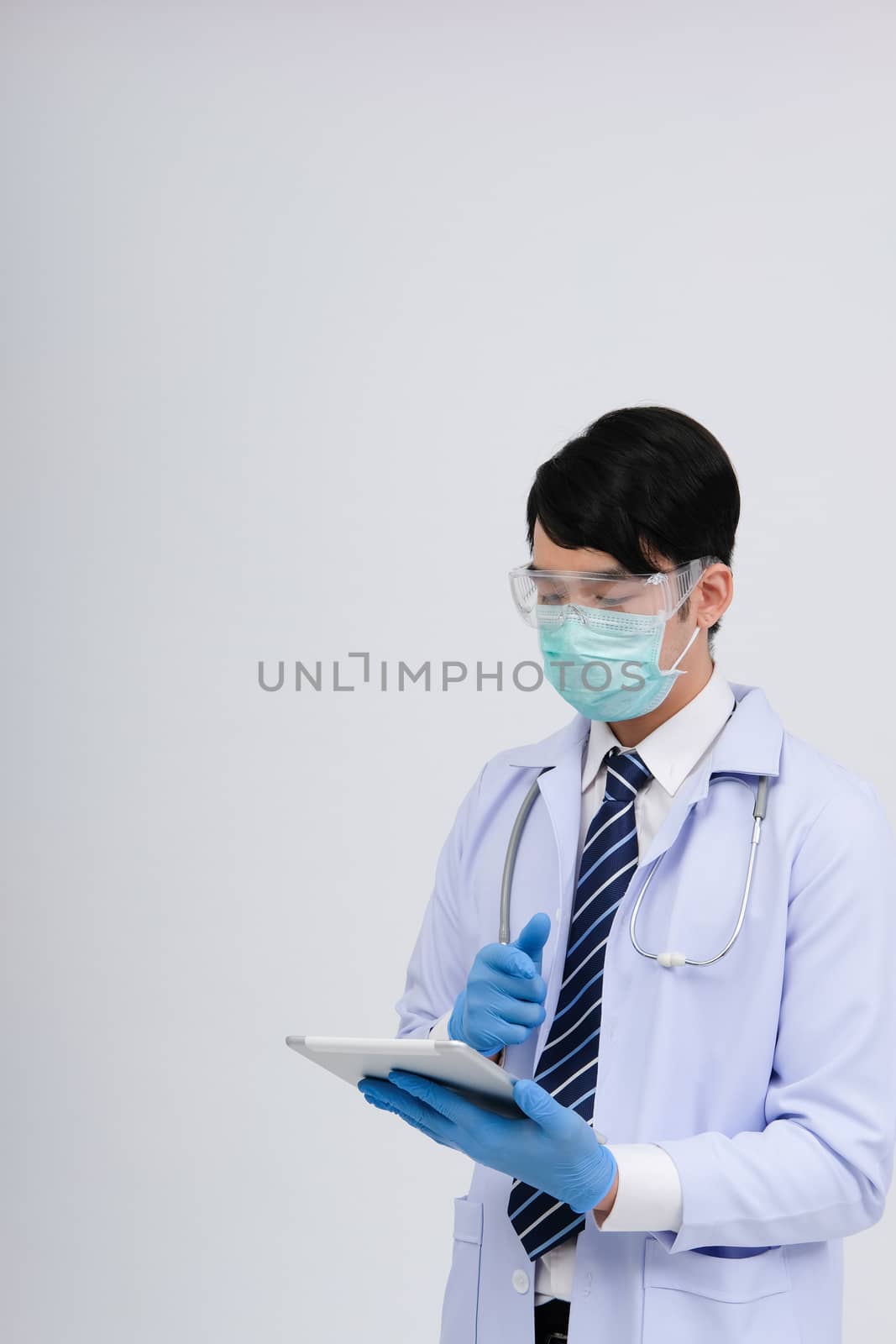 doctor physician practitioner wearing mask with tablet & stethoscope on white background. medical professional medicine healthcare concept