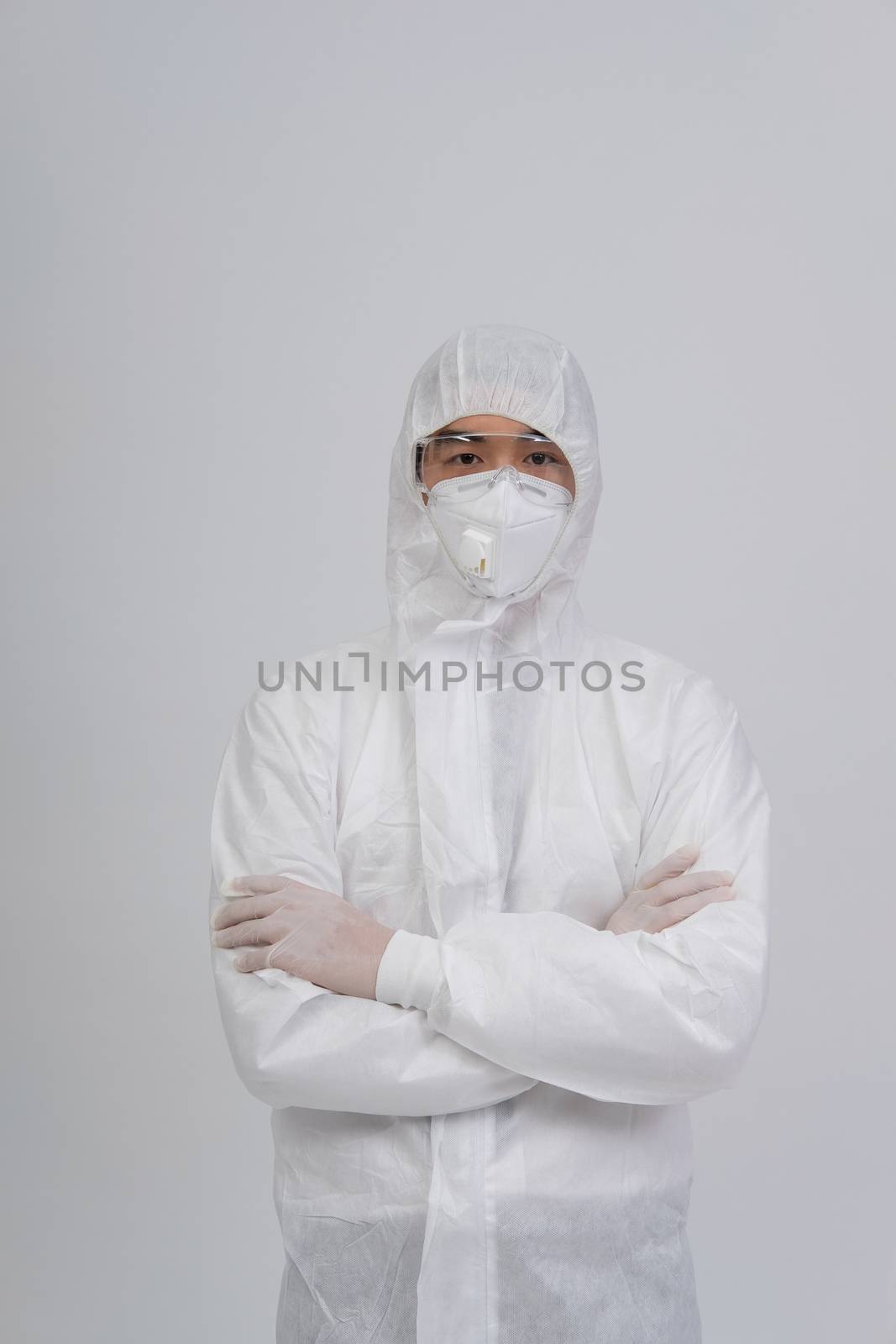 man doctor wearing biological protective uniform suit clothing, mask, gloves for preventing virus bacteria infection contamination