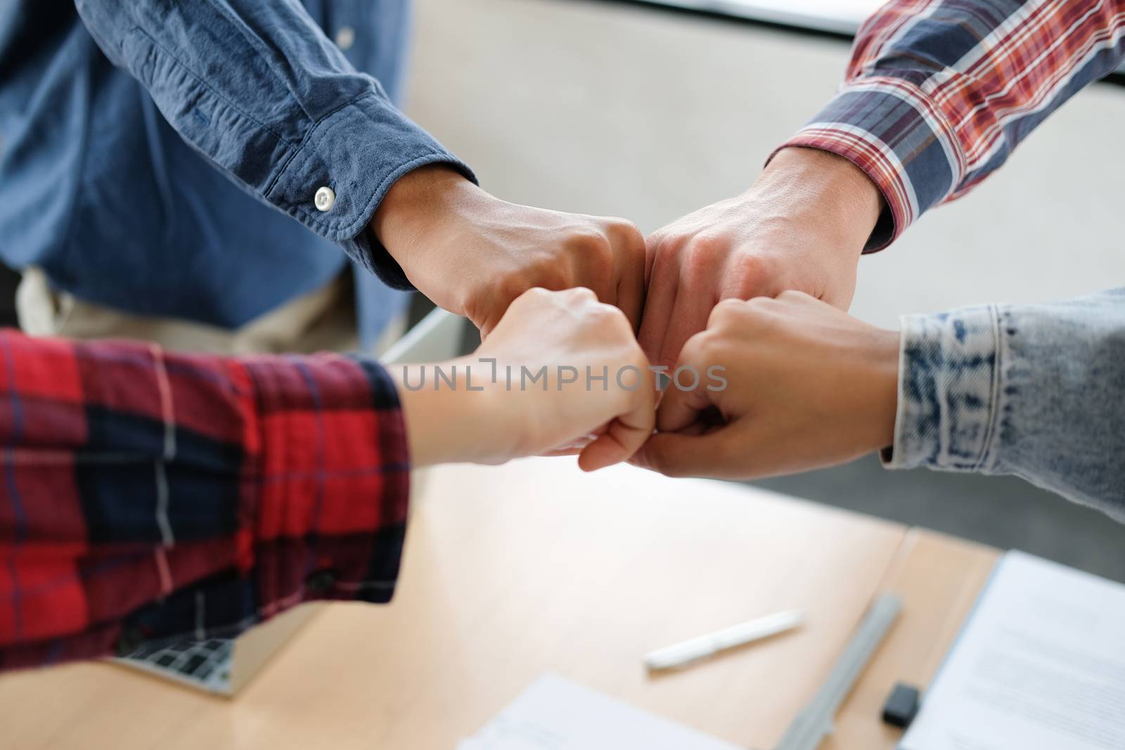 startup man woman joining united hand, business team touching hands together after complete a deal in meeting. unity teamwork partnership corporate concept.