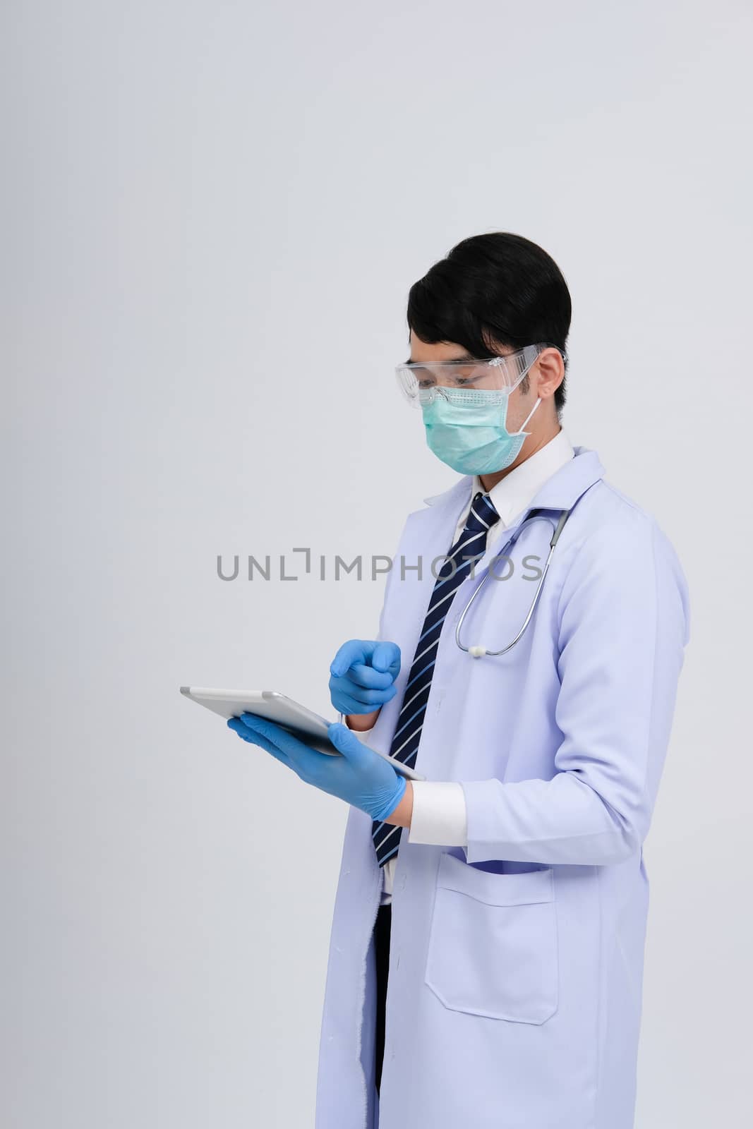 doctor physician practitioner wearing mask with tablet & stethoscope on white background. medical professional medicine healthcare concept